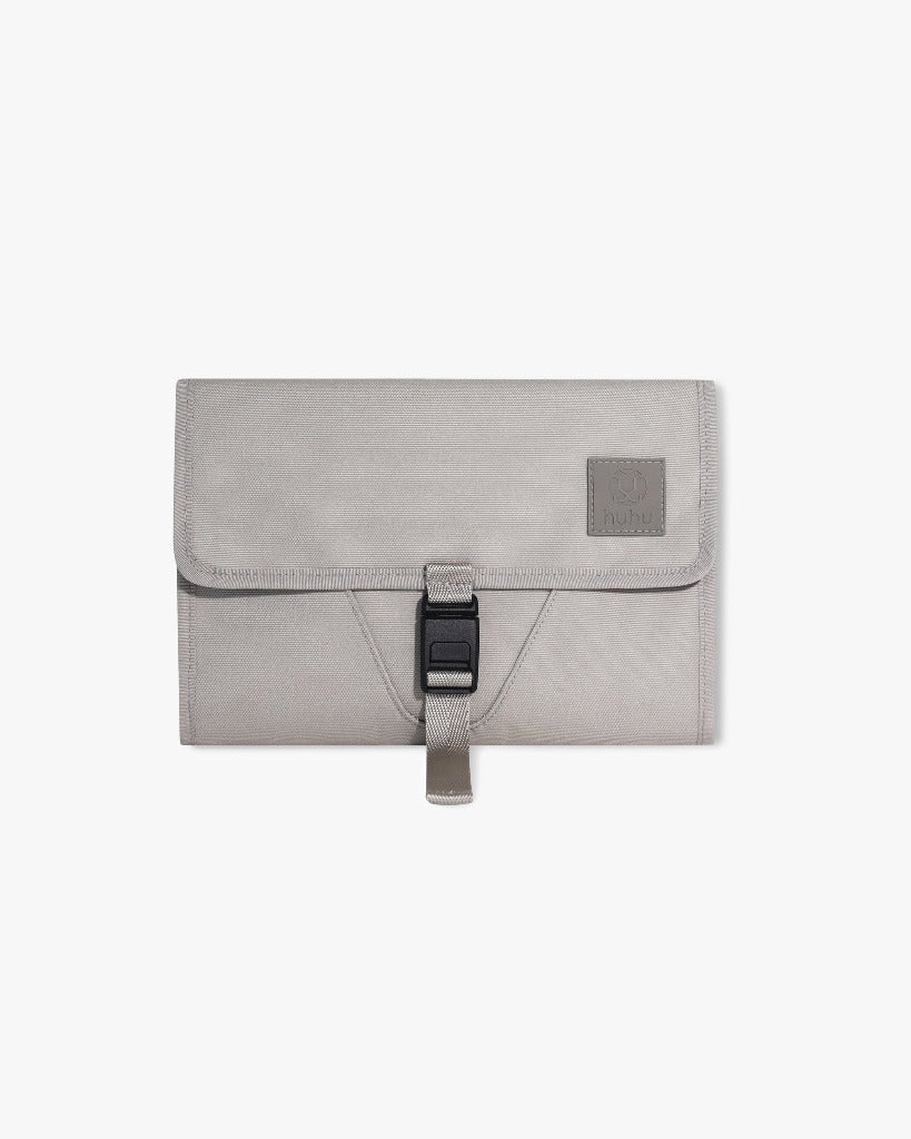 Front view of the taupe changing wallet against a white surface
