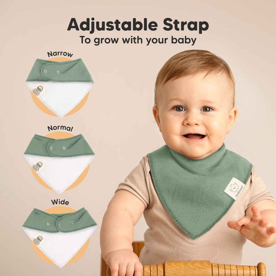 Baby wearing a green bib with adjustable strap options displayed on a beige background