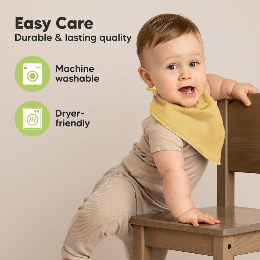 Baby sitting on a wooden chair wearing a yellow bib, with text about easy care and machine washability.