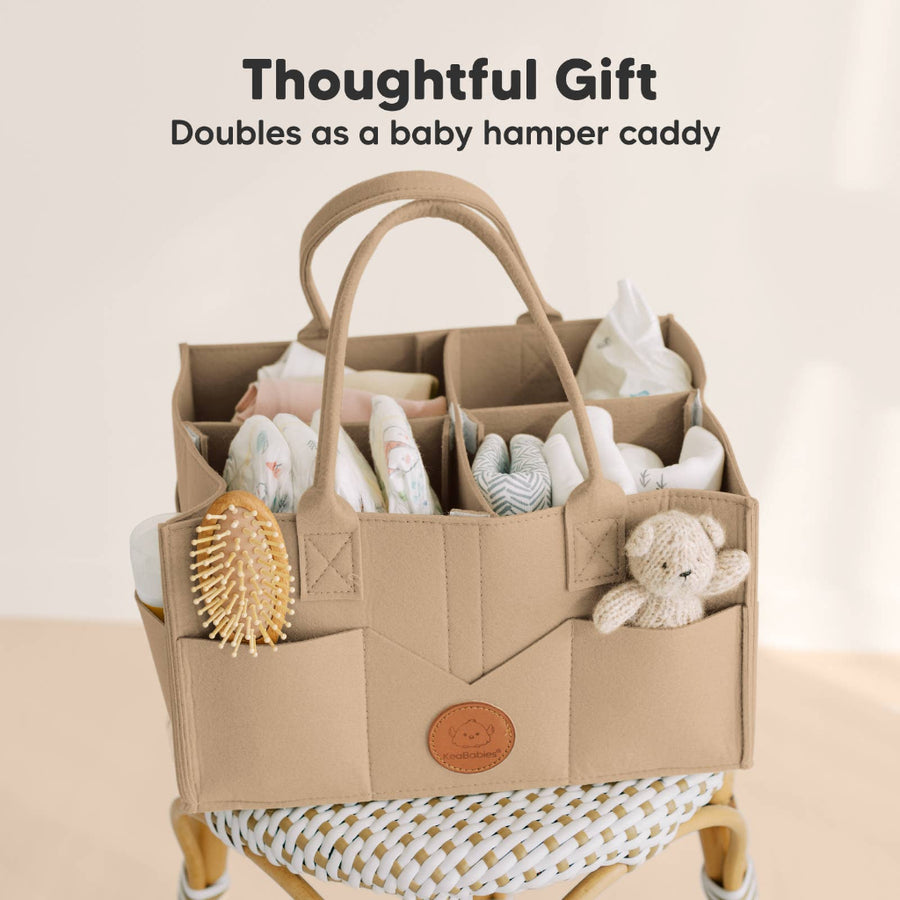 Baby hamper caddy with baby items on a beige background