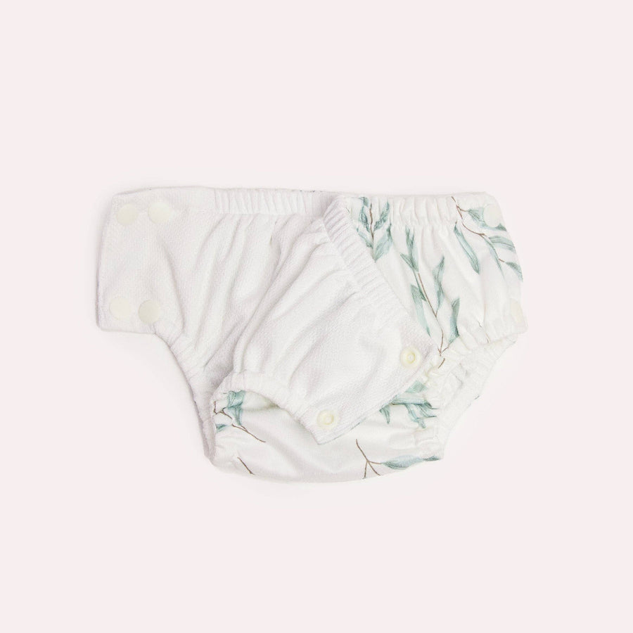 Baby swim diaper with floral pattern on a light pink background