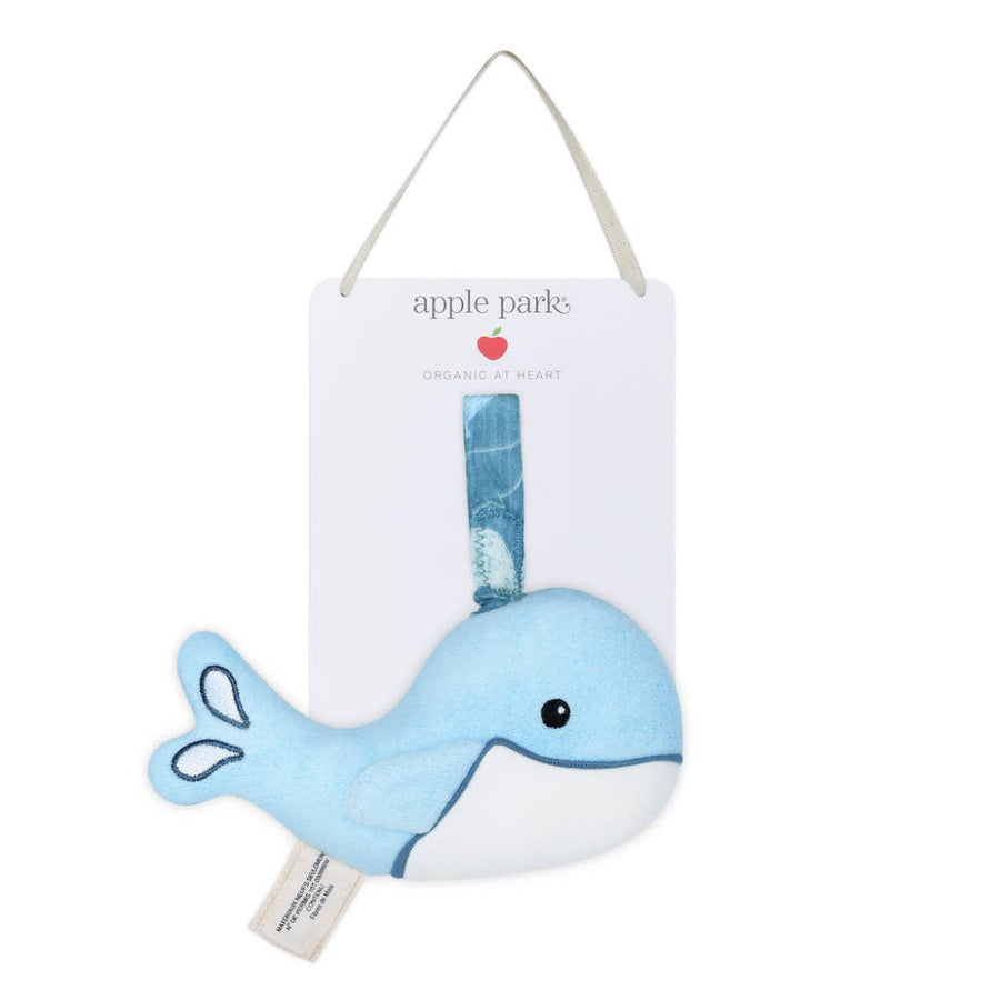 Blue whale plush toy with a white label on a white background