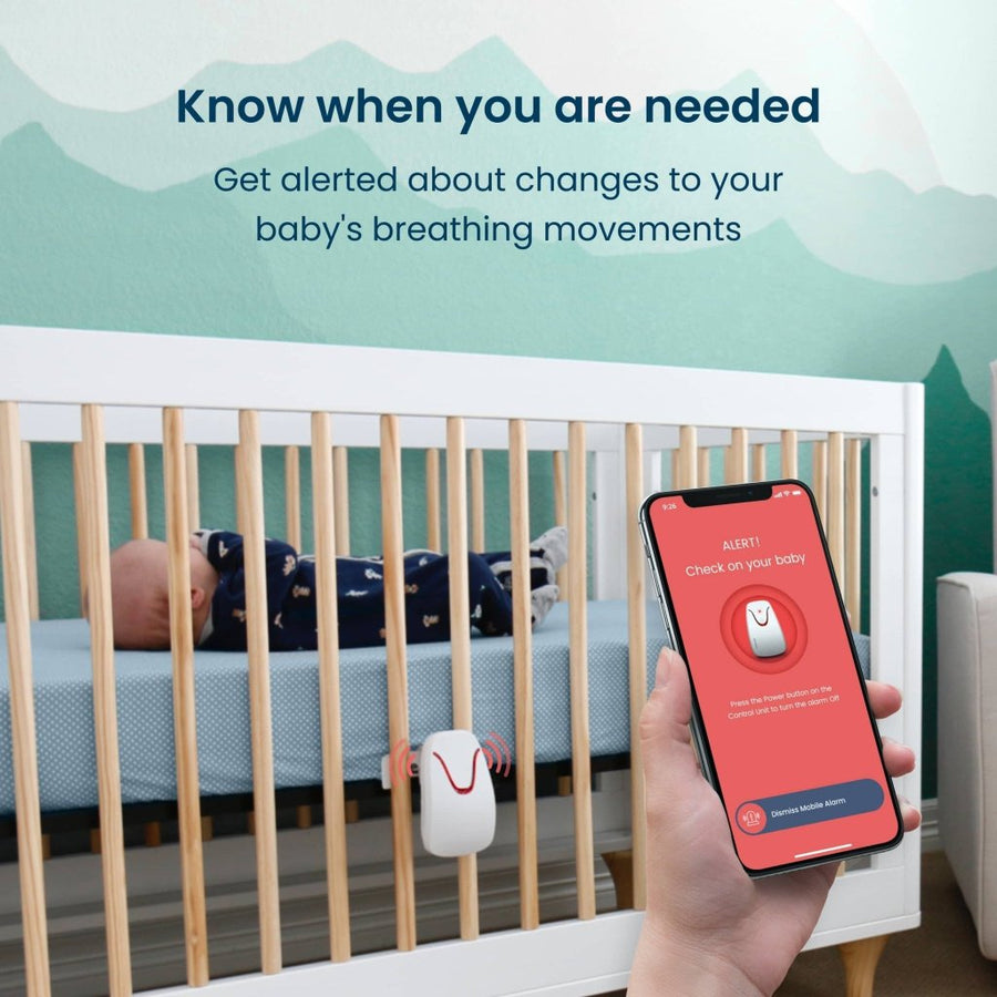 Image of a baby in a crib with a monitor installed, and a hand in the foreground holding a smartphone showing a red monitor alert on the screen, with text at the top of the image that reads, 