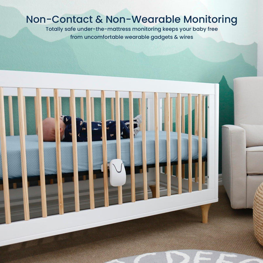Image of a baby lying in a crib with the monitor attached. Text reads, 