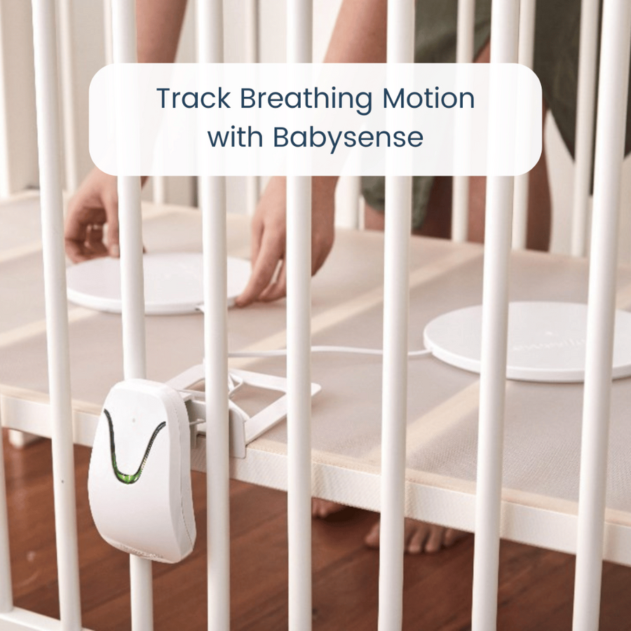 Image of a person placing the pads in a crib, with text reading 