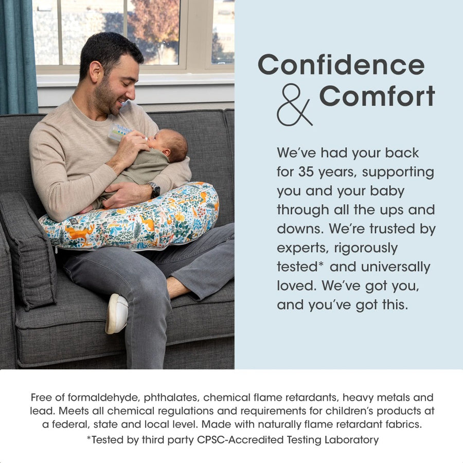 Man sitting on a couch holding a baby, with text about confidence and comfort.