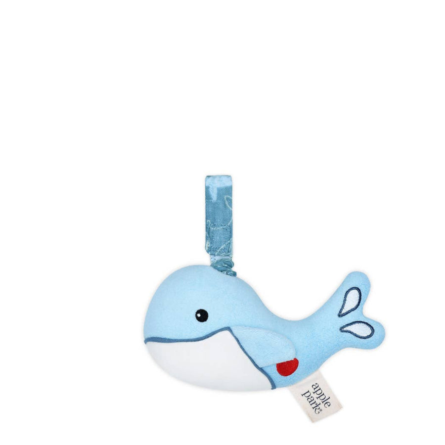 Blue whale-shaped toy with a red apple on its side, on a white background