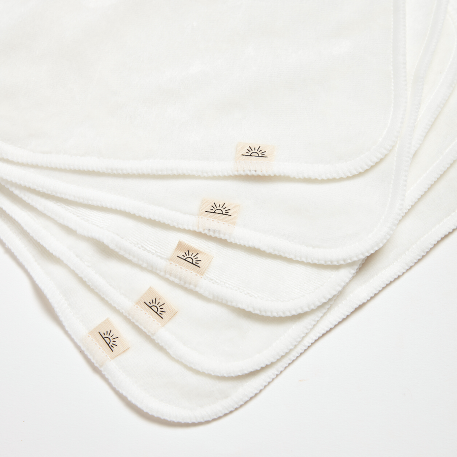 Stack of white cloths with a brand logo on a white background