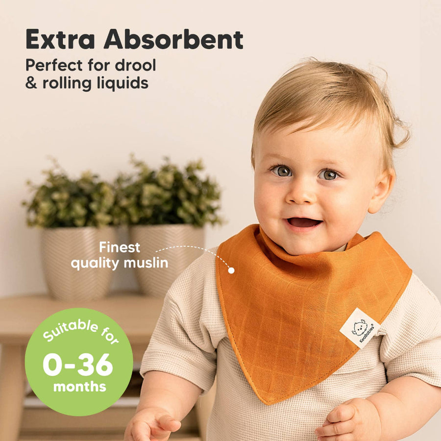 Baby wearing an orange bib with text about absorbency and suitability for babies aged 0-36 months.