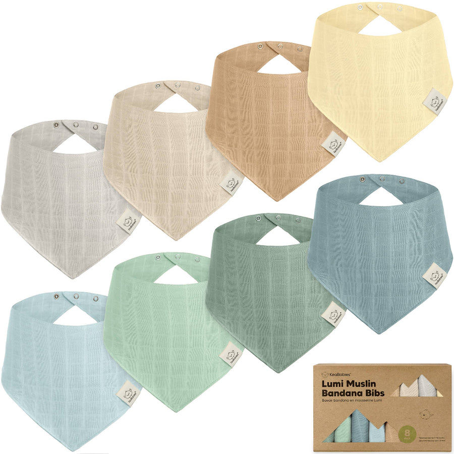 Set of colorful bandana bibs with a branded box on a white background