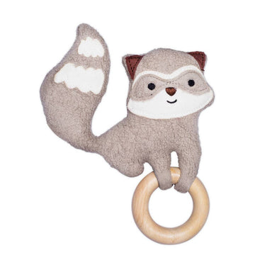 Stuffed raccoon toy with a wooden ring on a white background