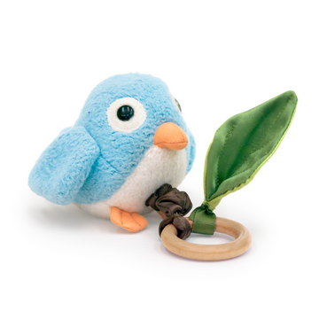 Blue plush bird toy with a wooden ring and leaf on a white background