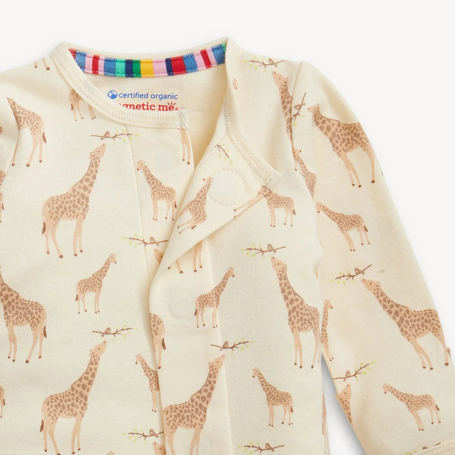 Baby onesie with giraffe pattern on a cream background