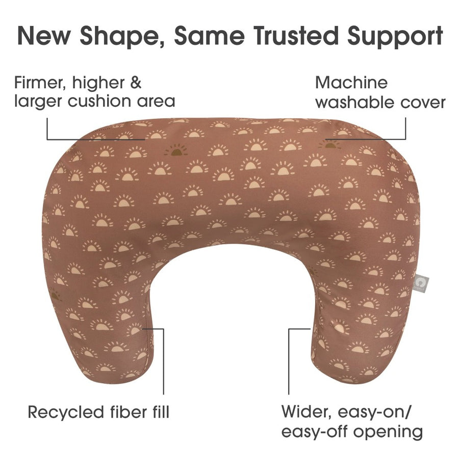 Breastfeeding pillow with patterned cover on a white background, featuring text about its features.