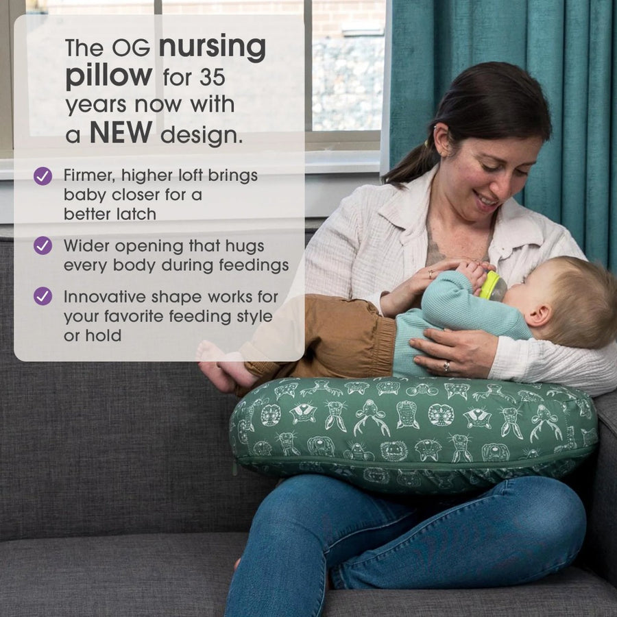 Woman using a green nursing pillow with text about its features