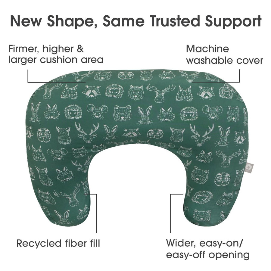 Green nursing pillow with animal pattern on a white background, featuring text about its features.