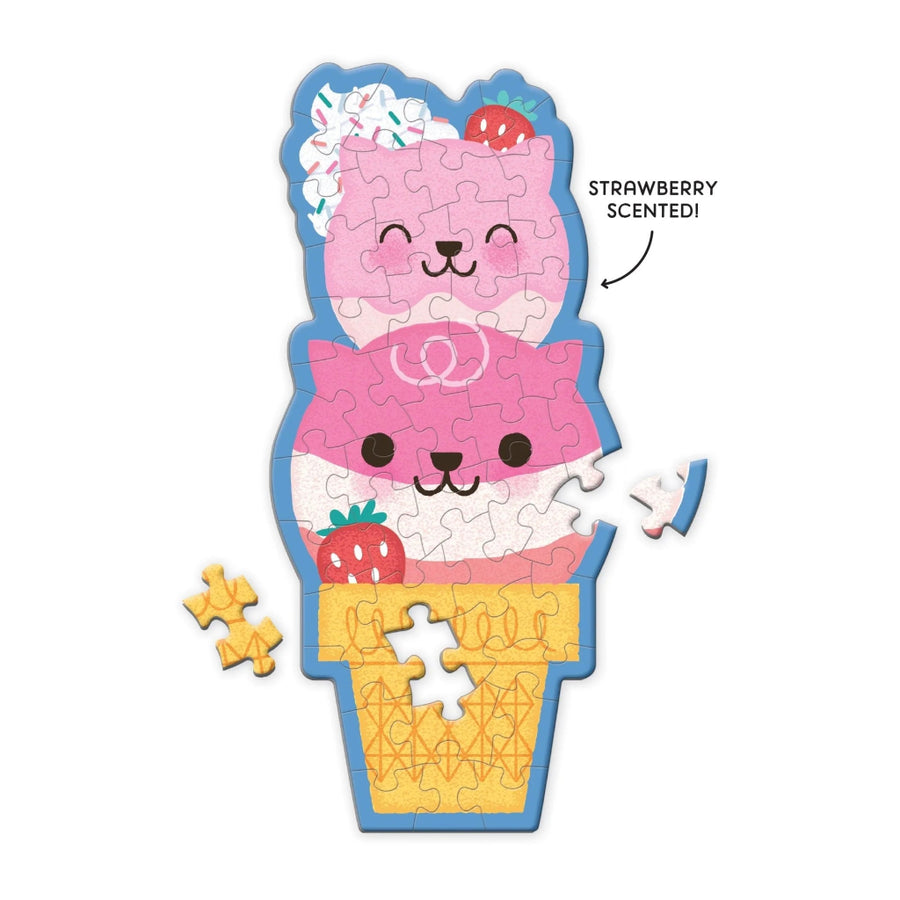 Strawberry scented puzzle shaped like a ice cream cone with a cat design on a white background.
