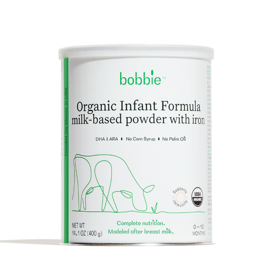 Picture of a can of Bobbie formula. The label has a stylized drawing of a cow eating grass and the label reads, 