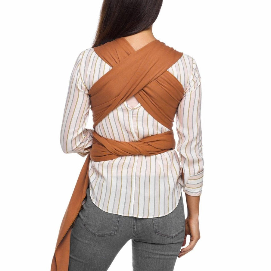 Back view of woman wearing caramel colored moby wrap evolution showing crossed fabric