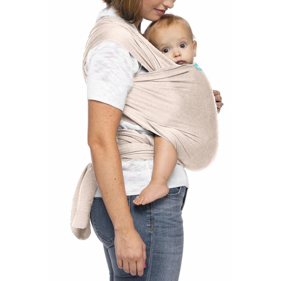 Picture of a woman wearing a pale beige colored Moby Evolution baby wrap with baby