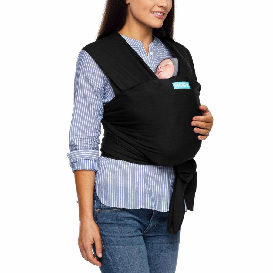 Picture of a woman wearing black Moby Evolution baby wrap with infant