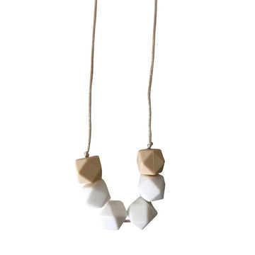 Picture of a teething necklace made of beige and white geometric silicone beads on a white satin cord